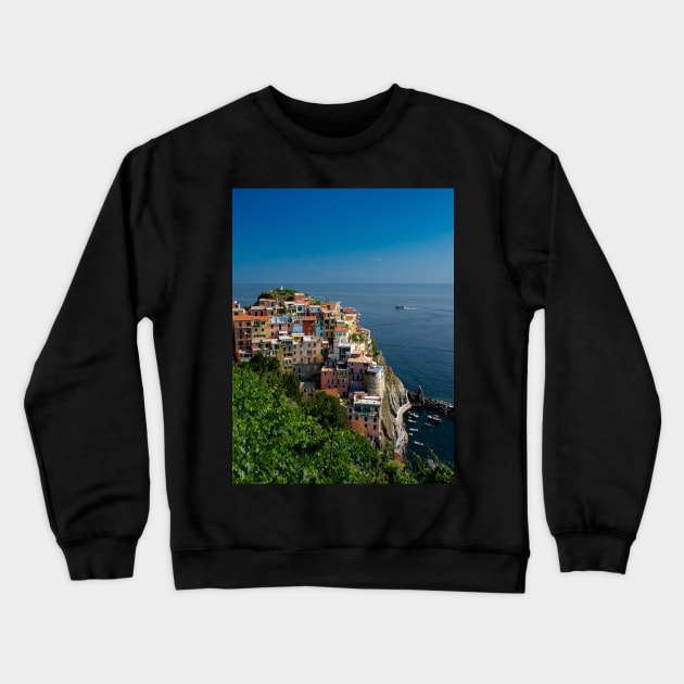 View on the cliff town of Manarola, one of the colorful Cinque Terre on the Italian west coast Crewneck Sweatshirt by Dolfilms